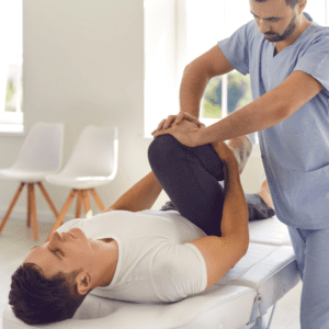 a man lying down with a nurse attending to his injured foot