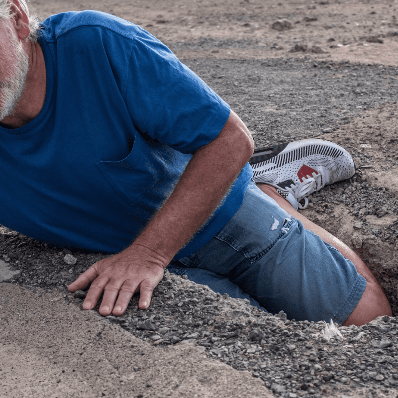 A man falls into a ground hollow