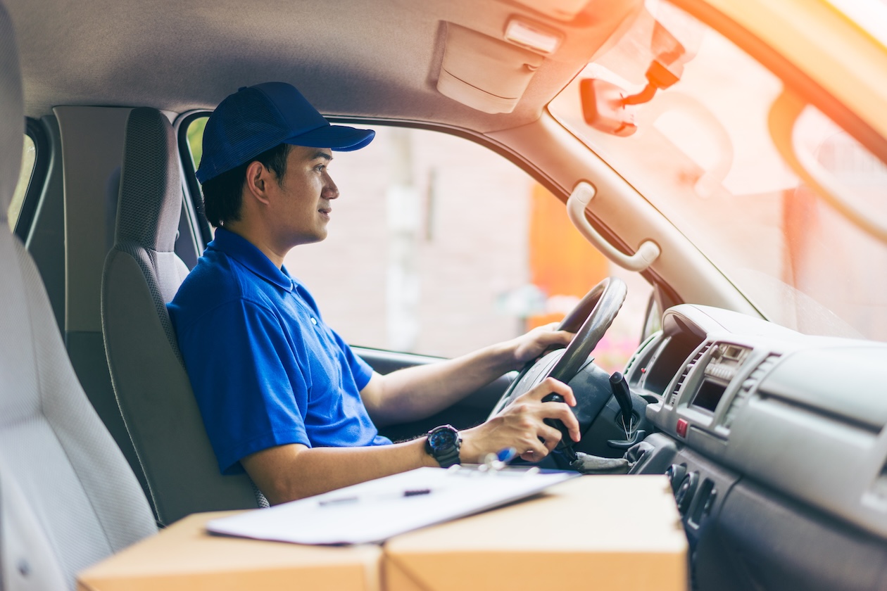 Delivery driver with boxes in the front seat.