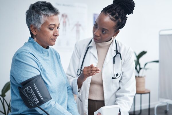 Senior patient reviewing medical results with doctor during an office visit, illustrating how pre-existing health conditions are evaluated in personal injury claims