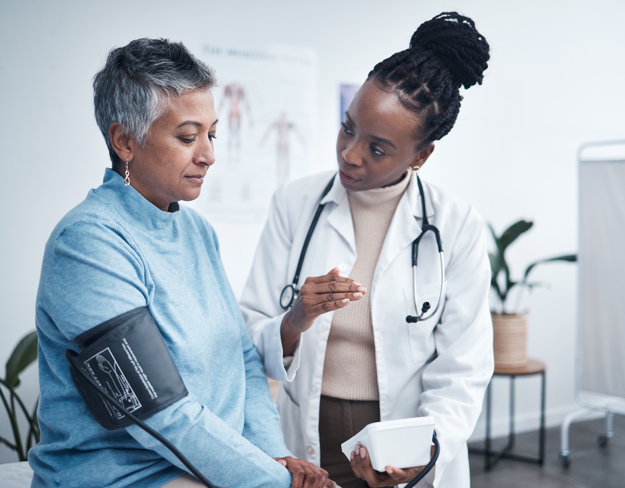 Senior patient reviewing medical results with doctor during an office visit, illustrating how pre-existing health conditions are evaluated in personal injury claims