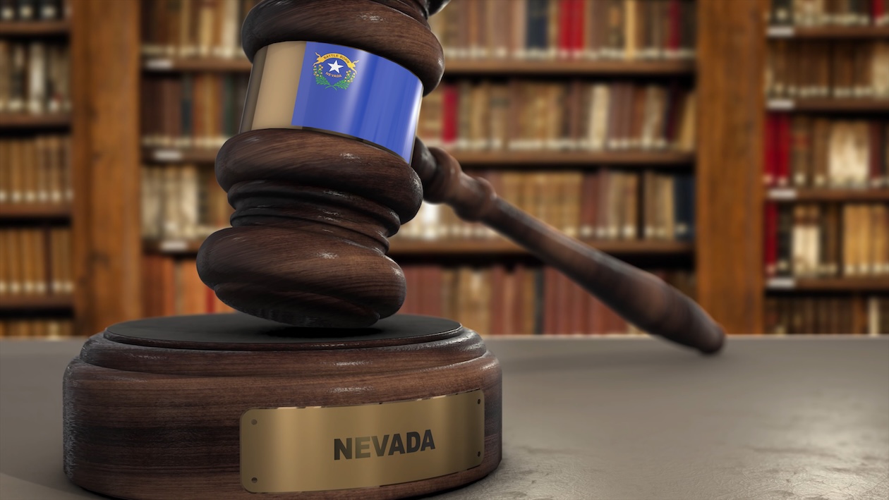 Nevada state flag behind a judge’s gavel symbolizing Nevada personal injury and accident law.